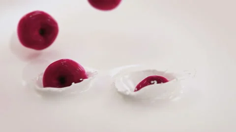 Cherries Falling Into Milk in 4K Super slow motion Stock Footage 141029254