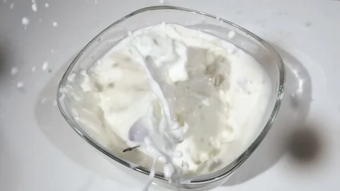 Cherries falling into milk in slow motion 스톡 동영상 77002084