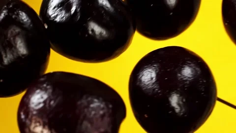 Cherries fly on a yellow background in slow motion Stock Footage 151119046
