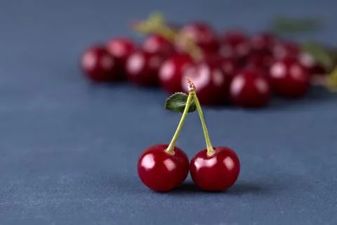 Cherries on grey stone background Stock Photos