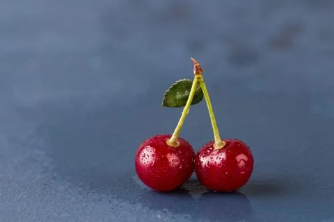 Cherries on grey stone background Stock Photos