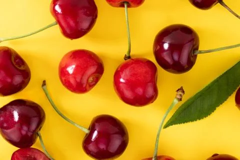 Cherries pattern on yellow background. Top view. Flat lay Stock Photos