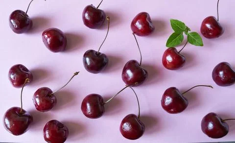 Cherries on a pink background. Top view. Flat lay. Stock Photos