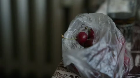 Cherries in a plastic bag on the table Stock Footage 237454397