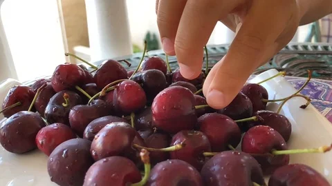 Cherries on plate Stock Footage 111444443