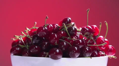 Cherries on a red background, slow motion 240 fps Video stock 56689340