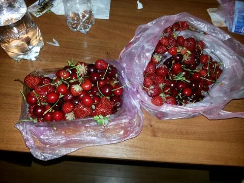 Cherris in bag on table Stock Photos