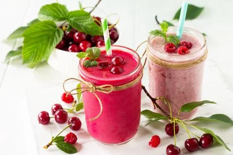 Cherry and raspberry fruit Yogurt smoothie or milk shake in glass jar. Stock Photos