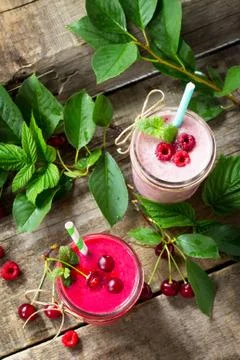 Cherry and raspberry fruit Yogurt smoothie or milk shake in glass jar. Stock Photos