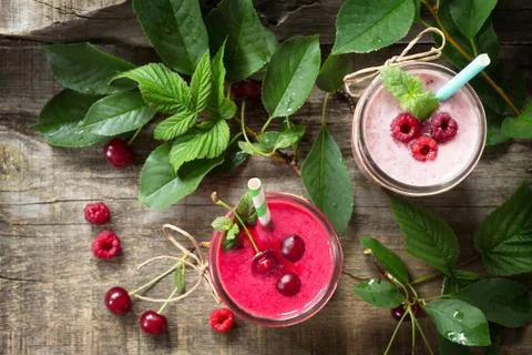 Cherry and raspberry fruit Yogurt smoothie or milk shake in glass jar. Stock Photos
