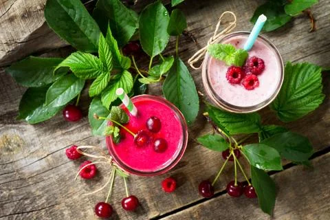 Cherry and raspberry fruit Yogurt smoothie or milk shake in glass jar. Stock Photos