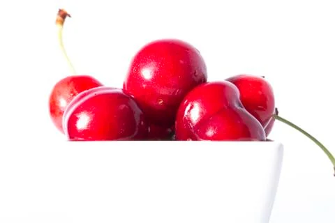 Cherry Berries In A Cup On A White Background Stock Photos
