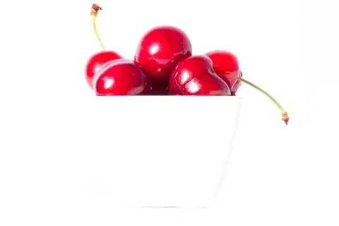 Cherry Berries In A Cup On A White Background Stock Photos