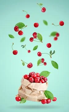 Cherry berries levitating on a blue background. Background with copy space Foto stock