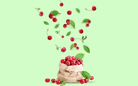 Cherry berries levitating on a green background. Background with copy space Foto stock