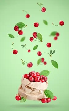 Cherry berries levitating on a green background. Background with copy space. Foto stock