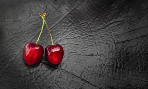 Cherry berries pair on dark background Stock Photos