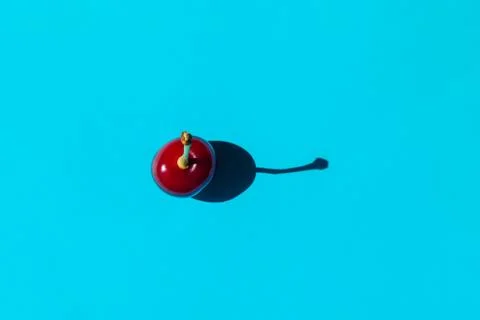 Cherry berry with a hard shadow on a plain background. the view from the top Foto stock