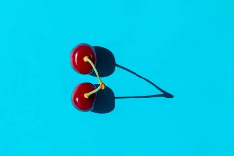 Cherry berry with a hard shadow on a plain background. the view from the top 스톡 사진