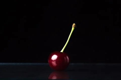 Cherry on a black background. Stock Photos