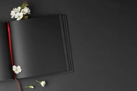 Cherry blossoms with an open black notebook Stock Photos