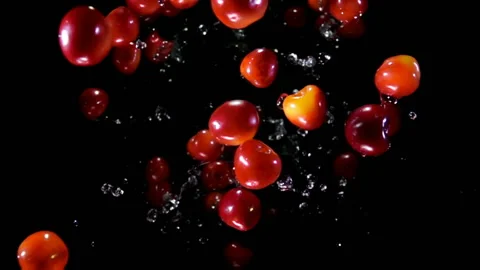 Cherry bouncing against to the camera with water Stock Footage 204074969
