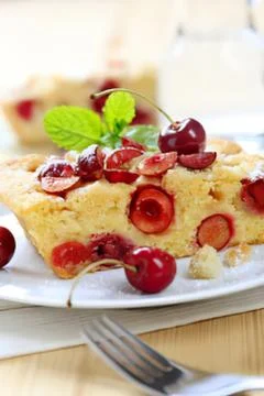 Cherry cake slice on white plate with fork Stock Photos