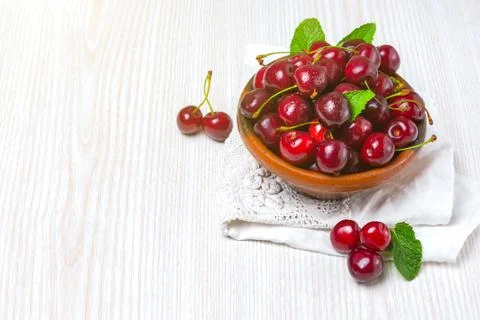 Cherry, Cherry in a clay plate on the table Stock Photos