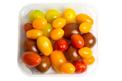 Cherry colored tomatoes in a plastic container on white background, isolated. Stock Photos