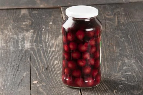 Cherry compote in a glass jar Stock Photos