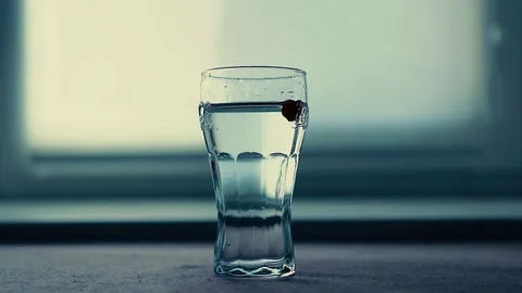 Cherry in cup of water Stock Footage 97386669