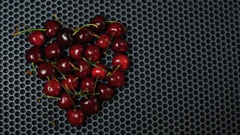 Cherry on a dark background on the top left close up, place to paste Stock Photos