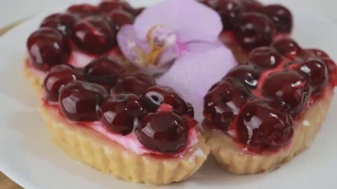Cherry dessert rotating on a white plate Stock Footage 69196492