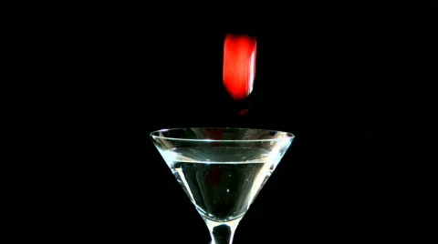 Cherry dropping into Martini Glass Slow Motion Stock Footage 668475