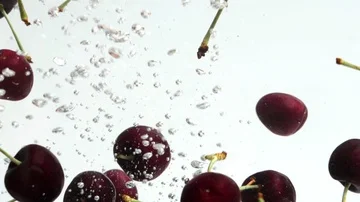 Cherry Dropping in Water Stock Footage