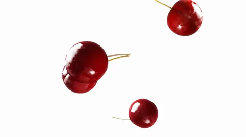 Cherry falling down white Stock Footage 24977101