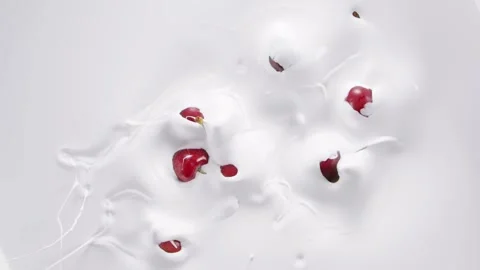 Cherry falling into the milk and rotating Stock Footage 171887818