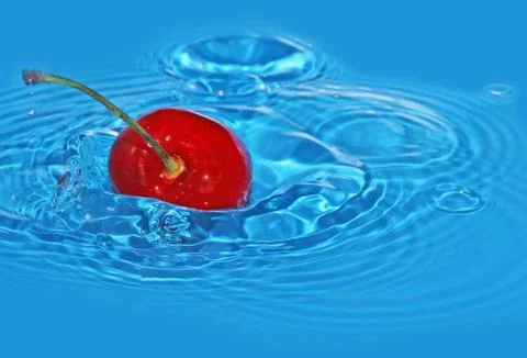 Cherry falls in water Stock Photos