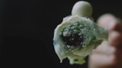 Cherry filled cake bite held close to the camera Stock Footage 342129722