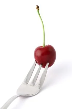 Cherry on a fork Stock Photos