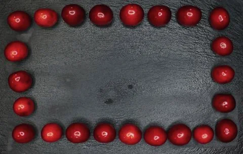 Cherry frame on a black background. Place to write a text Stock Photos