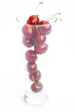 Cherry in a glass isolated on white Stock Photos