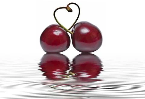 Cherry heart reflected on water. Stock Photos