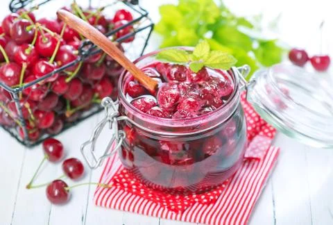 Cherry jam and berries Stock Photos