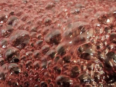 Cherry jam. Boiling jam surface. Background of bubbles on cherry jam Foto stock