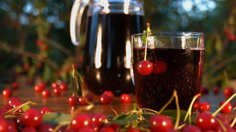 Cherry juice on the background of growing cherries. Видео 79612034