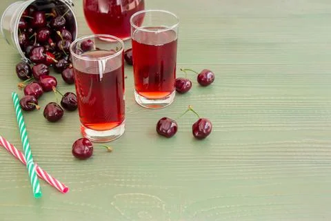 Cherry juice, cherries and empty space. Stock Photos