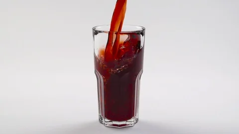 Cherry juice is poured into an empty glass. close up. Slow motion. 240fps. twist Stock Footage 102621154