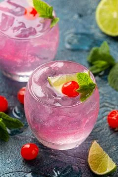 Cherry Limeade or Lemonade in drinking glass. Refreshing summer drink. Stock Photos