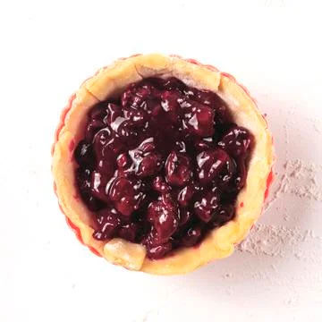 Cherry mini pie is almost ready to bake. Cooking process Stock Photos